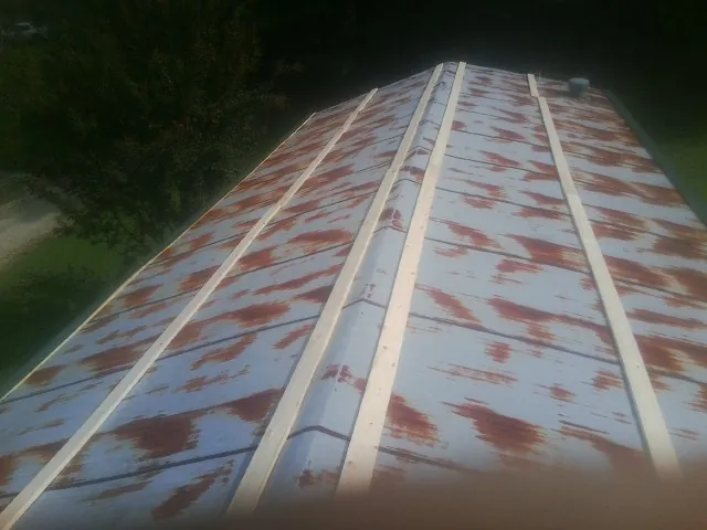 Rusted metal roof panels with new wood purlins before replacement — Storm Damage Roof Repair in Glen Aubrey by Roofing Brothers